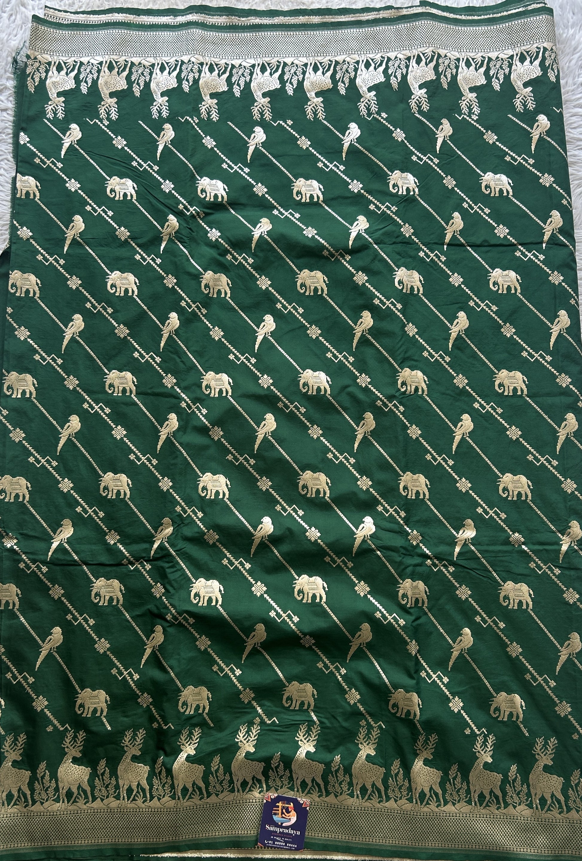 Semi Raw Silk Saree Bottle Green Colored Elegantly Paired with a Zari Border. - Sampradaya Designer Studio