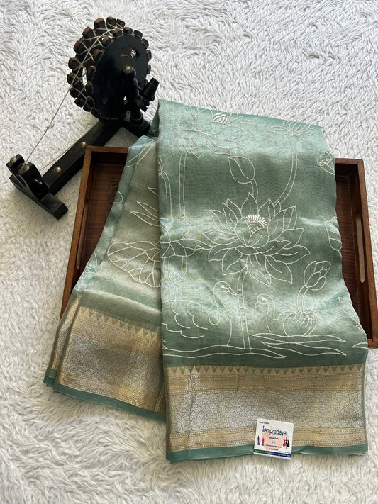 Banarasi Kora Saree Sea Foam Green Colored Complemented with a Silver And Gold Zari Border.