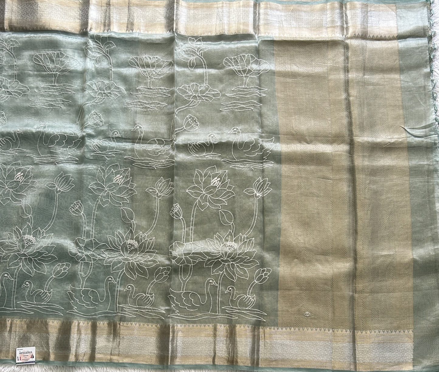 Banarasi Kora Saree Sea Foam Green Colored Complemented with a Silver And Gold Zari Border.