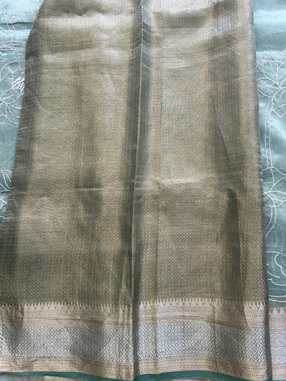 Banarasi Kora Saree Sea Foam Green Colored Complemented with a Silver And Gold Zari Border.