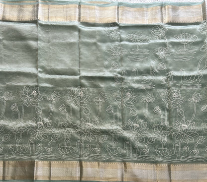 Banarasi Kora Saree Sea Foam Green Colored Complemented with a Silver And Gold Zari Border.
