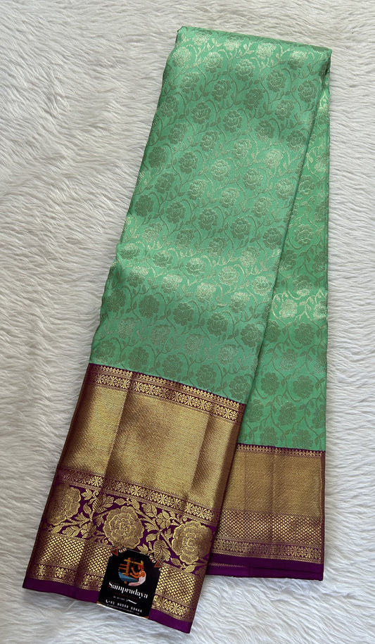 Kanjivaram Bridal Silk Saree Pastel Green colored allover Saree complemented with a Purple Colored Gold Kanchi border. - Sampradaya Designer Studio