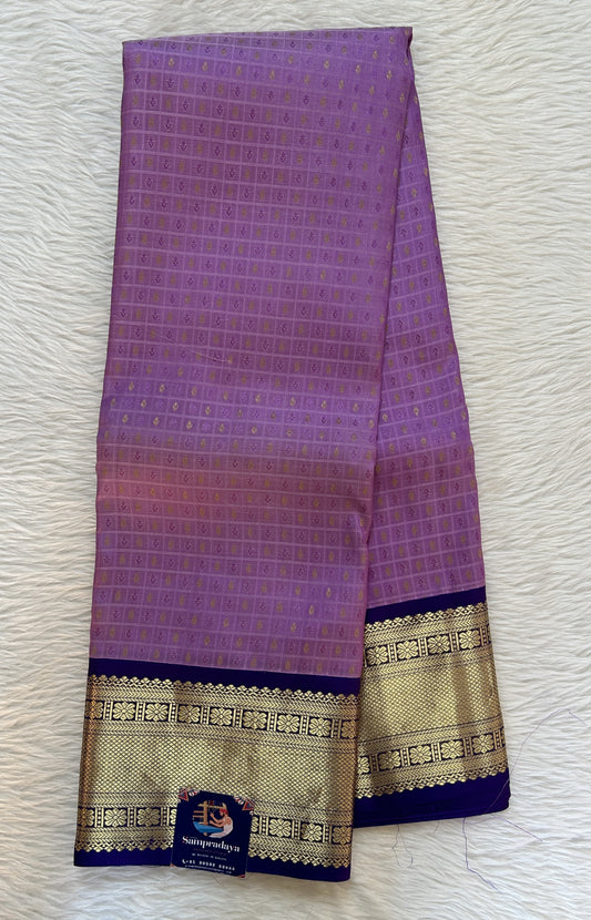 Kanjivaram Festive Silk Saree Lavender colored Saree complemented with a Indigo Blue Color Kanchi Border. - Sampradaya Designer Studio