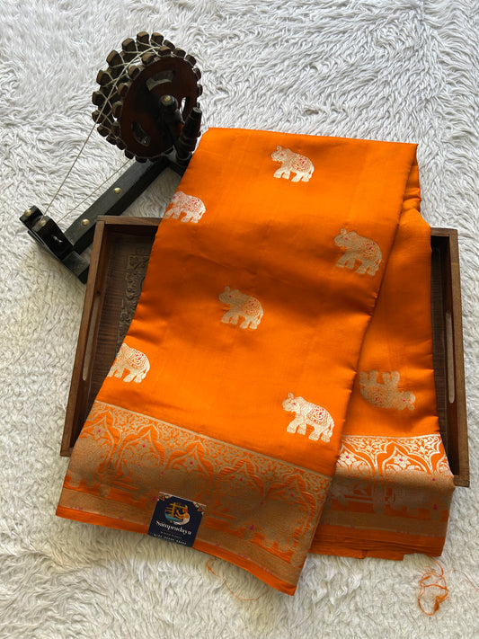Pure Chiniya Silk Saree Carrot Orange Colored Elegantly Paired with a Silver Zari Border.