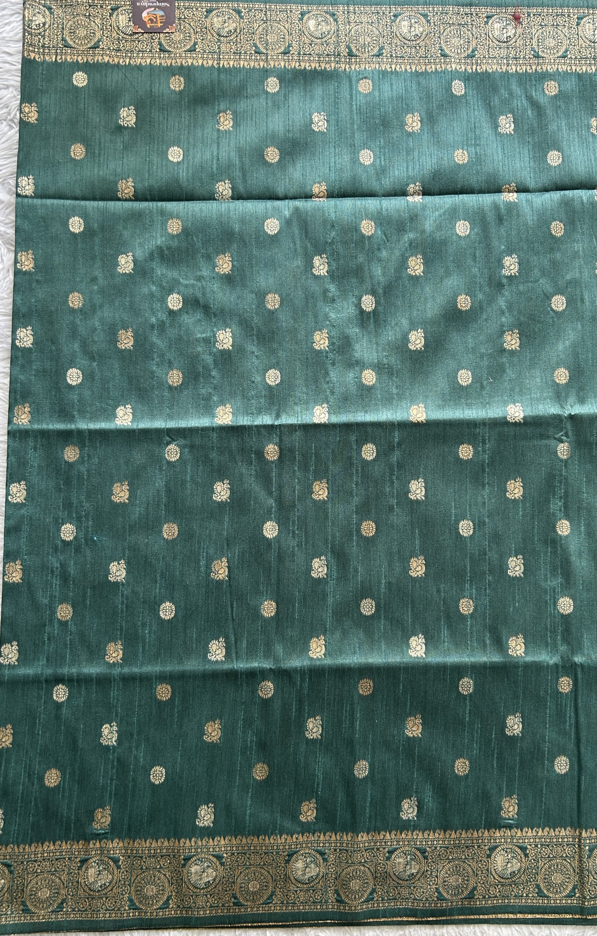 Semi Tussar Saree Bottle Green Colored complemented with a Zari Border. - Sampradaya Designer Studio