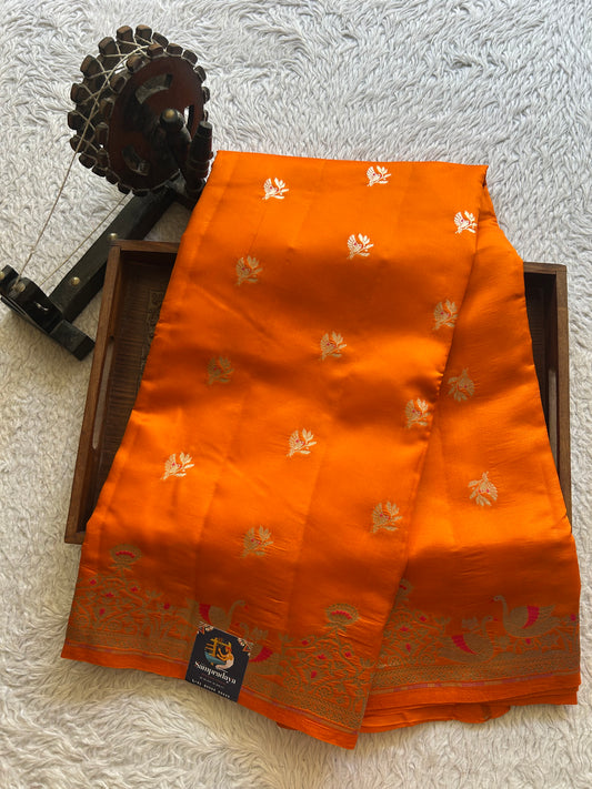 Pure Chiniya Silk Saree Orange Colored Elegantly Paired with a Silver Zari Border.