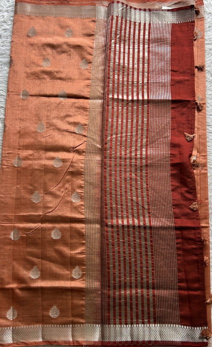 Semi Tussar Saree Peach Colored complemented with a Zari Border. - Sampradaya Designer Studio