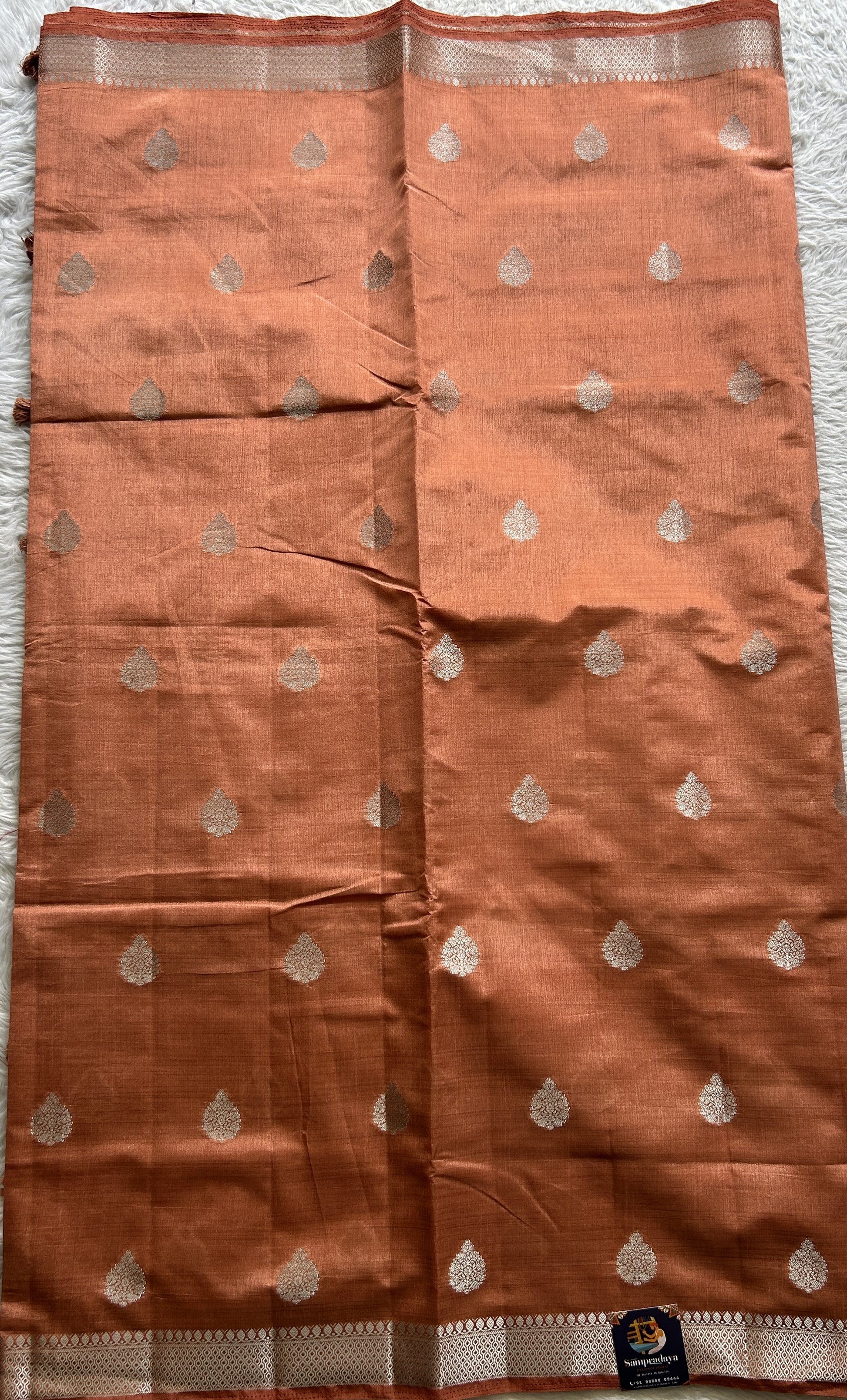 Semi Tussar Saree Peach Colored complemented with a Zari Border. - Sampradaya Designer Studio