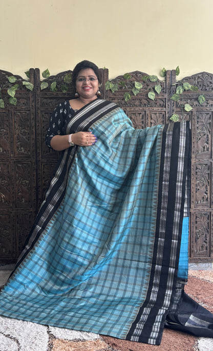 Gadwal Silk Saree Sea Blue Colored Complemented With a Black Zari Gap Border - Sampradaya Designer Studio