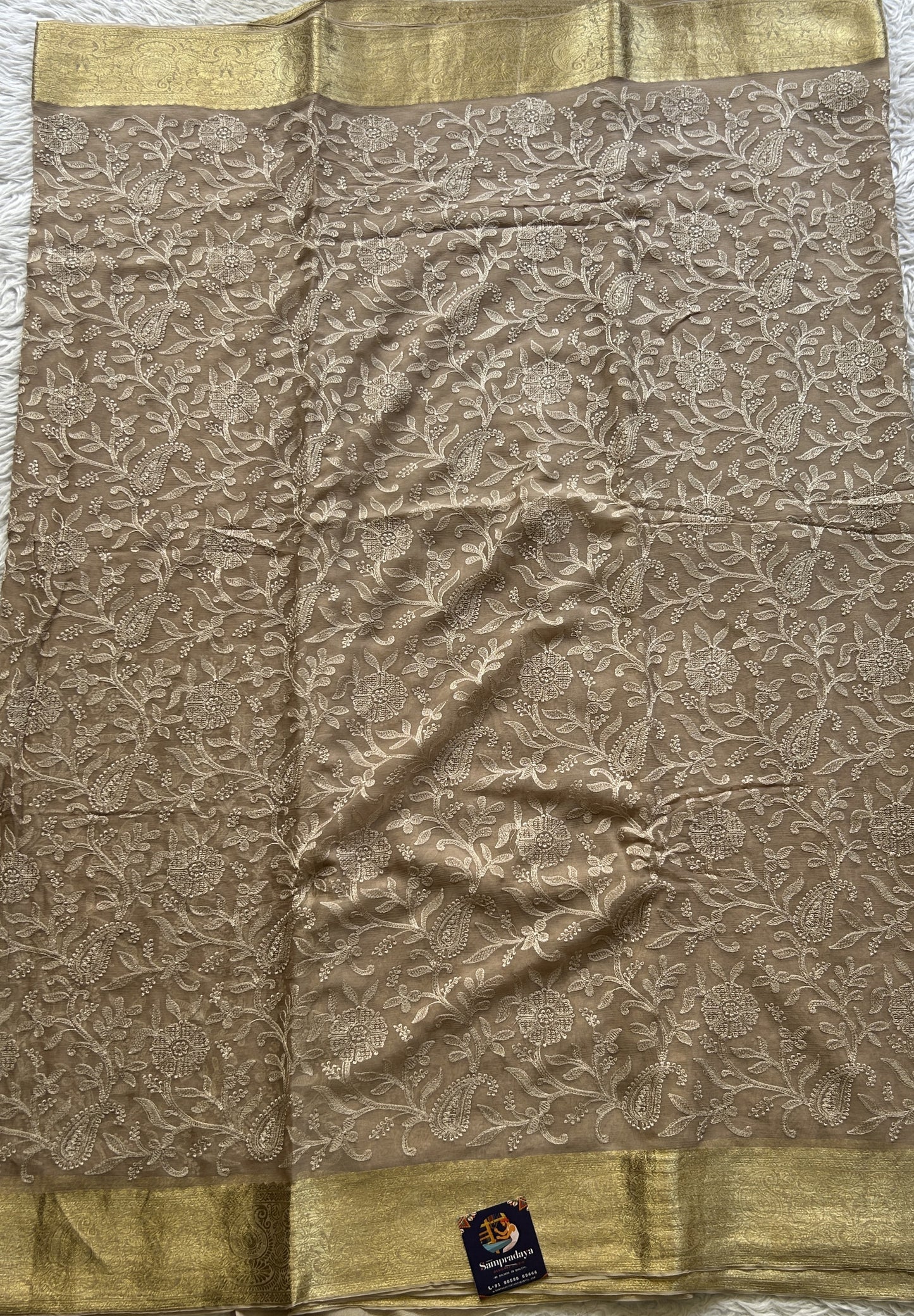 Semi Georgette Saree Very Light Brown Colored Elegantly Paired with a Zari Border. - Sampradaya Designer Studio