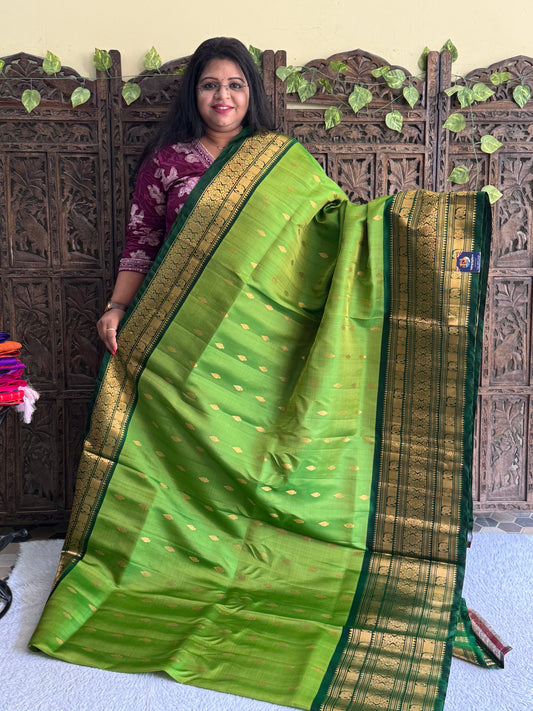 Gadwal Silk Saree Pea Green Colored Complemented With Gold Zari Border