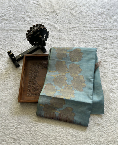 Semi Tussar Saree Sky Blue Colored complemented with a Embosed Border. - Sampradaya Designer Studio