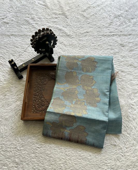 Semi Tussar Saree Sky Blue Colored complemented with a Embosed Border. - Sampradaya Designer Studio
