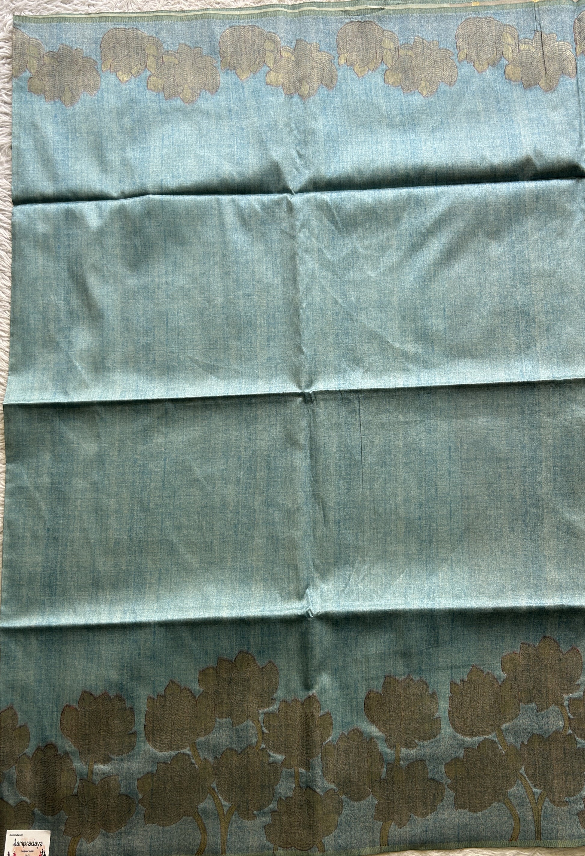 Semi Tussar Saree Sky Blue Colored complemented with a Embosed Border. - Sampradaya Designer Studio