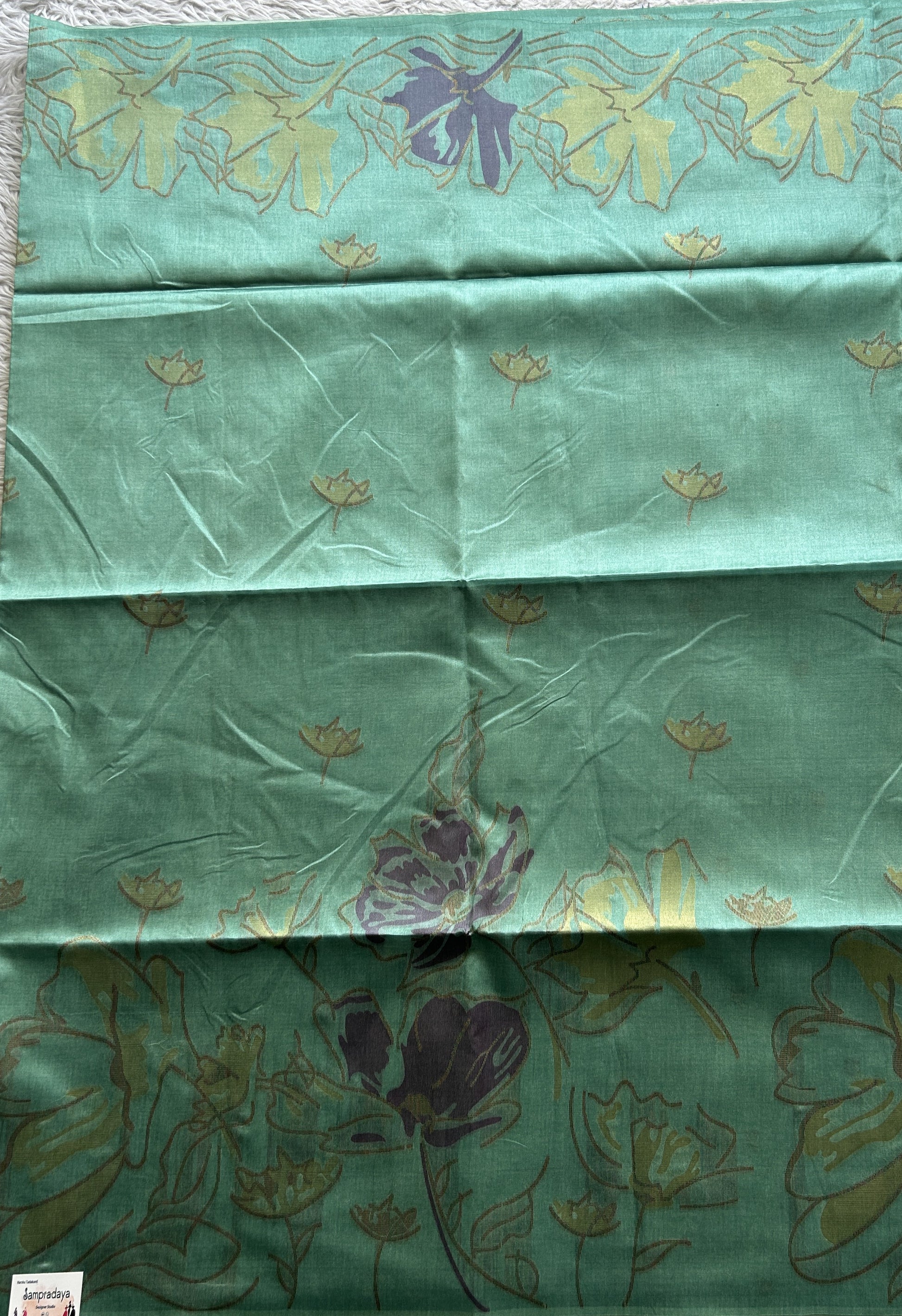 Semi Tussar Saree Ocean Green Colored complemented with a Embosed Border. - Sampradaya Designer Studio