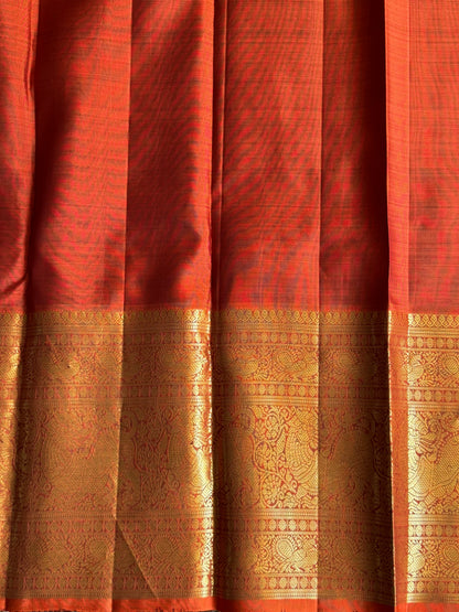 Pure Kanjivaram Silk Saree Chocolate brown Colored Elegantly Paid with a Gold Zari Border.