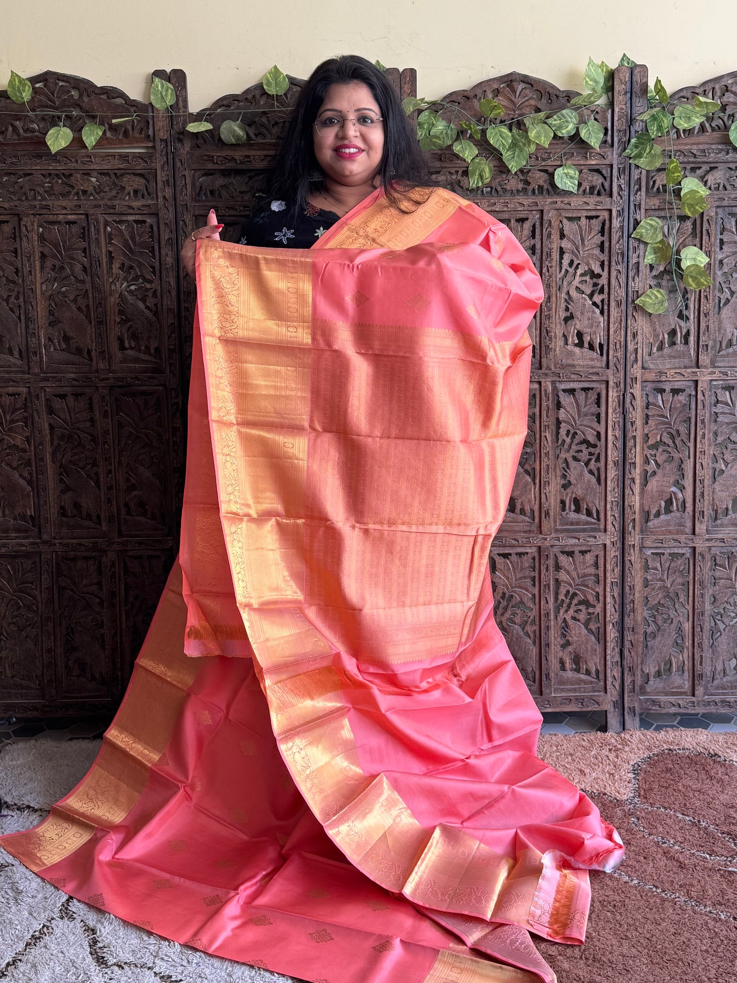 Pure Kanjivaram Silk Saree Peach Colored Elegantly Paid with a Gold Zari Border.