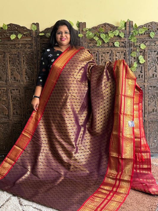 Pure Kanjivaram Silk Saree Burgundy Colored Complemented with a Gold Zari Border.