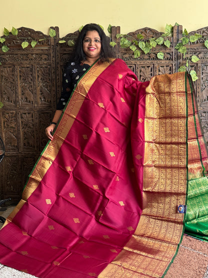 Pure Kanjivaram Silk Saree Wine Colored Elegantly Paid with a Gold Zari Border.