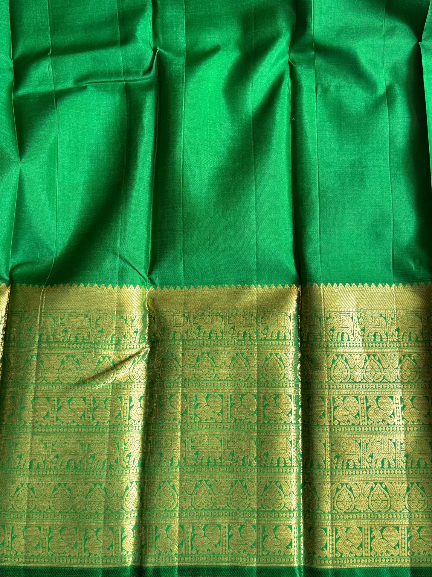Pure Kanjivaram Silk Saree Wine Colored Elegantly Paid with a Gold Zari Border.