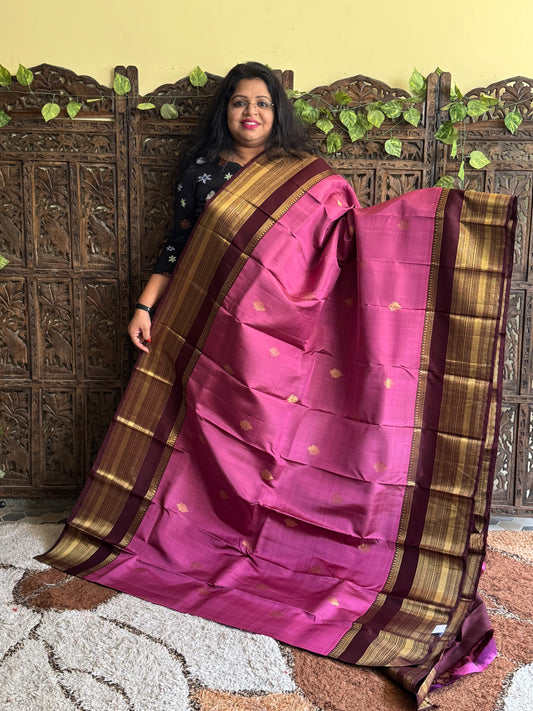 Pure Kanjivaram Silk Saree Lilac Colored Elegantly Paid with a Gold Zari Border.