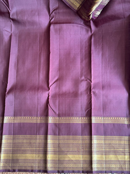 Pure Kanjivaram Silk Saree Lilac Colored Elegantly Paid with a Gold Zari Border.