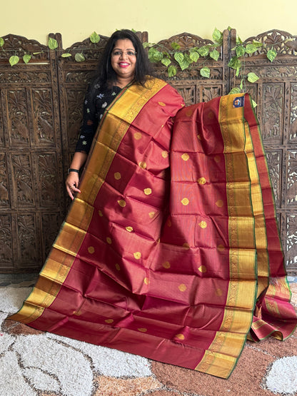 Pure Kanjivaram Silk Saree Dark Marron Colored Complemented with a Gold Zari Border.