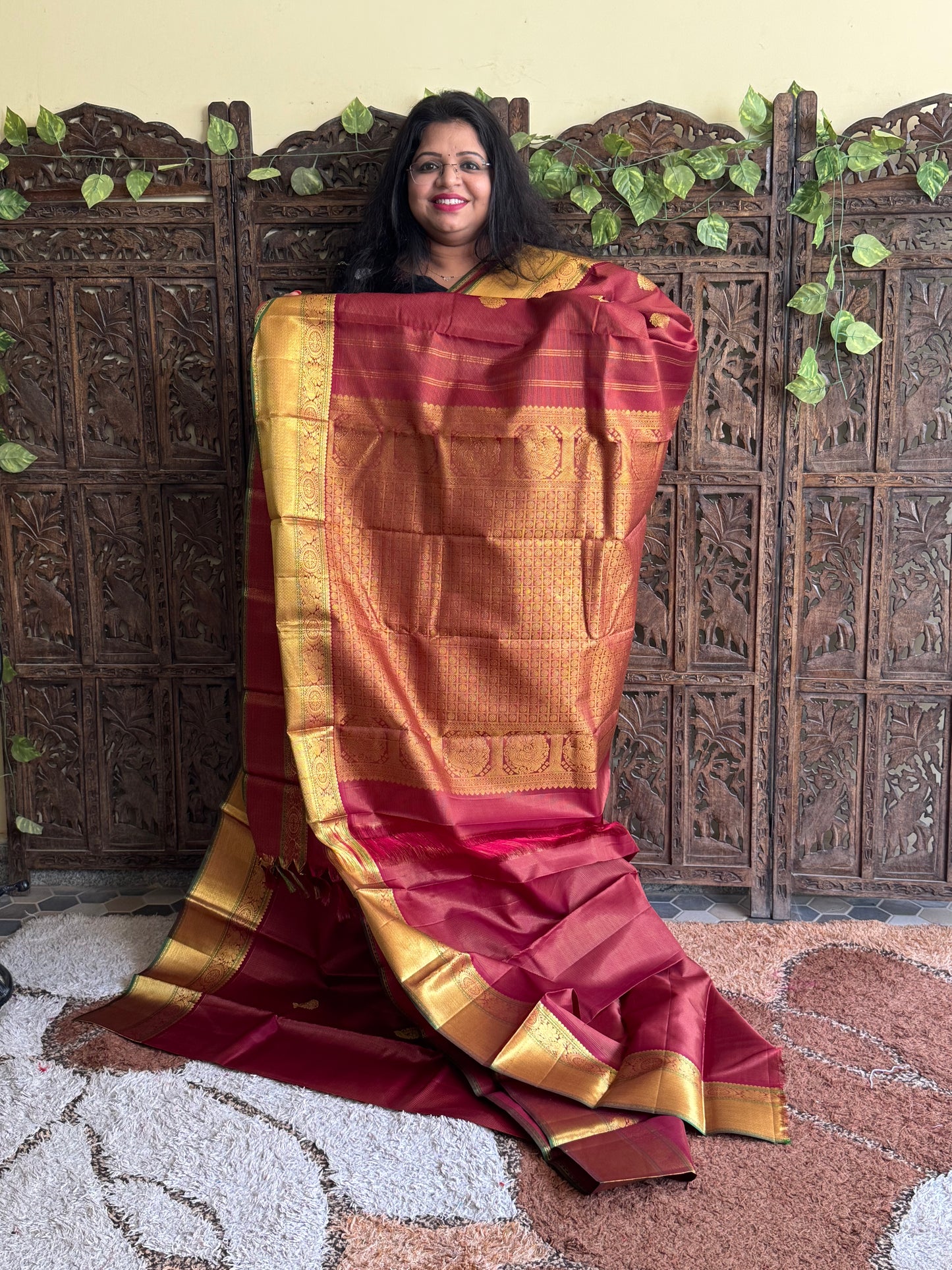 Pure Kanjivaram Silk Saree Dark Marron Colored Complemented with a Gold Zari Border.
