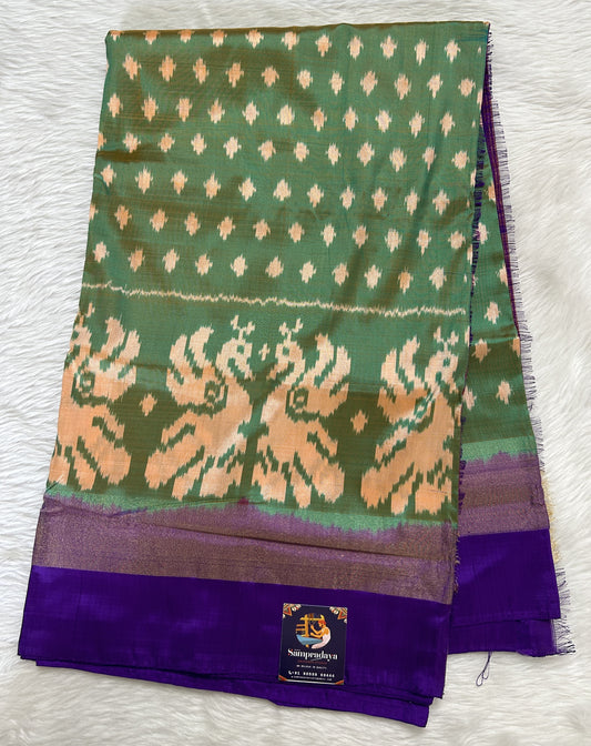 Ikkat Pattu Saree Green colored Saree complemented with a Purple Colored Plain border. - Sampradaya Designer Studio