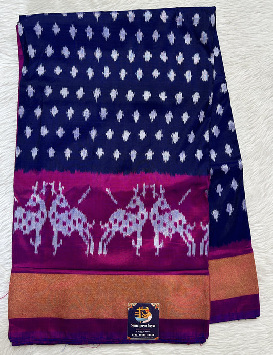 Ikkat Pattu Saree Ink Blue colored Saree complemented with a Purple Colored Gold Zari border. - Sampradaya Designer Studio