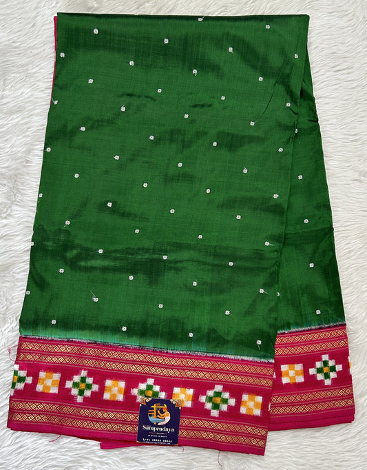 Ikkat Pattu Saree Bottle Green colored Saree complemented with a Pink Colored Ikkat border. - Sampradaya Designer Studio