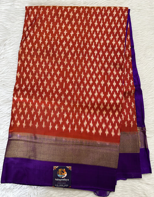 Ikkat Pattu Saree Rustic Orange colored Saree complemented with a Purple Colored Plain border. - Sampradaya Designer Studio