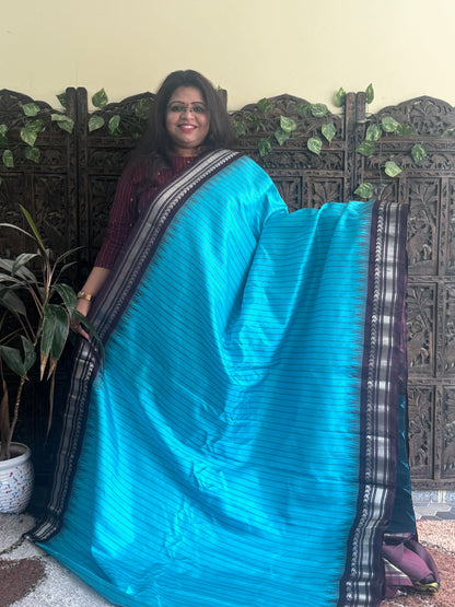 Gadwal Silk Saree Sky Blue Colored Complemented With a Brown Zari Border - Sampradaya Designer Studio