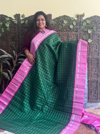 Gadwal Silk Saree Bottle Green Colored Complemented With a Pink Zari Border - Sampradaya Designer Studio
