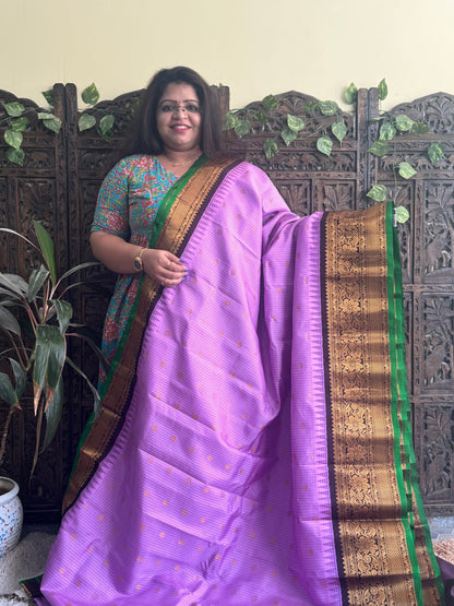 Gadwal Pattu Saree Lavender colored saree complemented with a Brown Zari border - Sampradaya Designer Studio