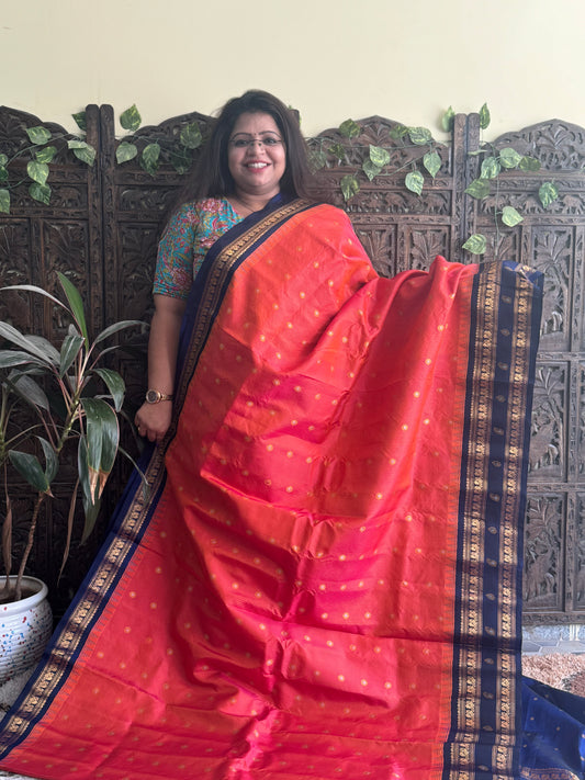 Gadwal Pattu Saree Dark Peach colored saree complemented with a Ink Blue Zari border - Sampradaya Designer Studio