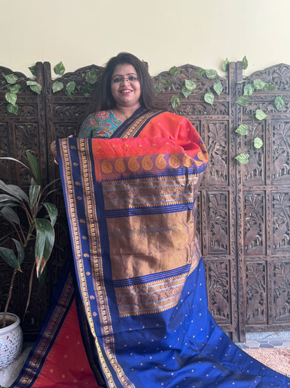 Gadwal Pattu Saree Dark Peach colored saree complemented with a Ink Blue Zari border - Sampradaya Designer Studio