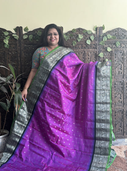 Gadwal Pattu Saree Purple colored saree complemented with a Black Zari border - Sampradaya Designer Studio