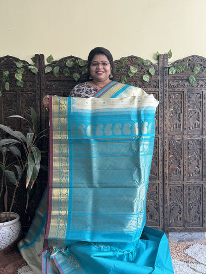 Gadwal Silk Saree Cream Colored Complemented With a Sea Blue Kanchi Border - Sampradaya Designer Studio