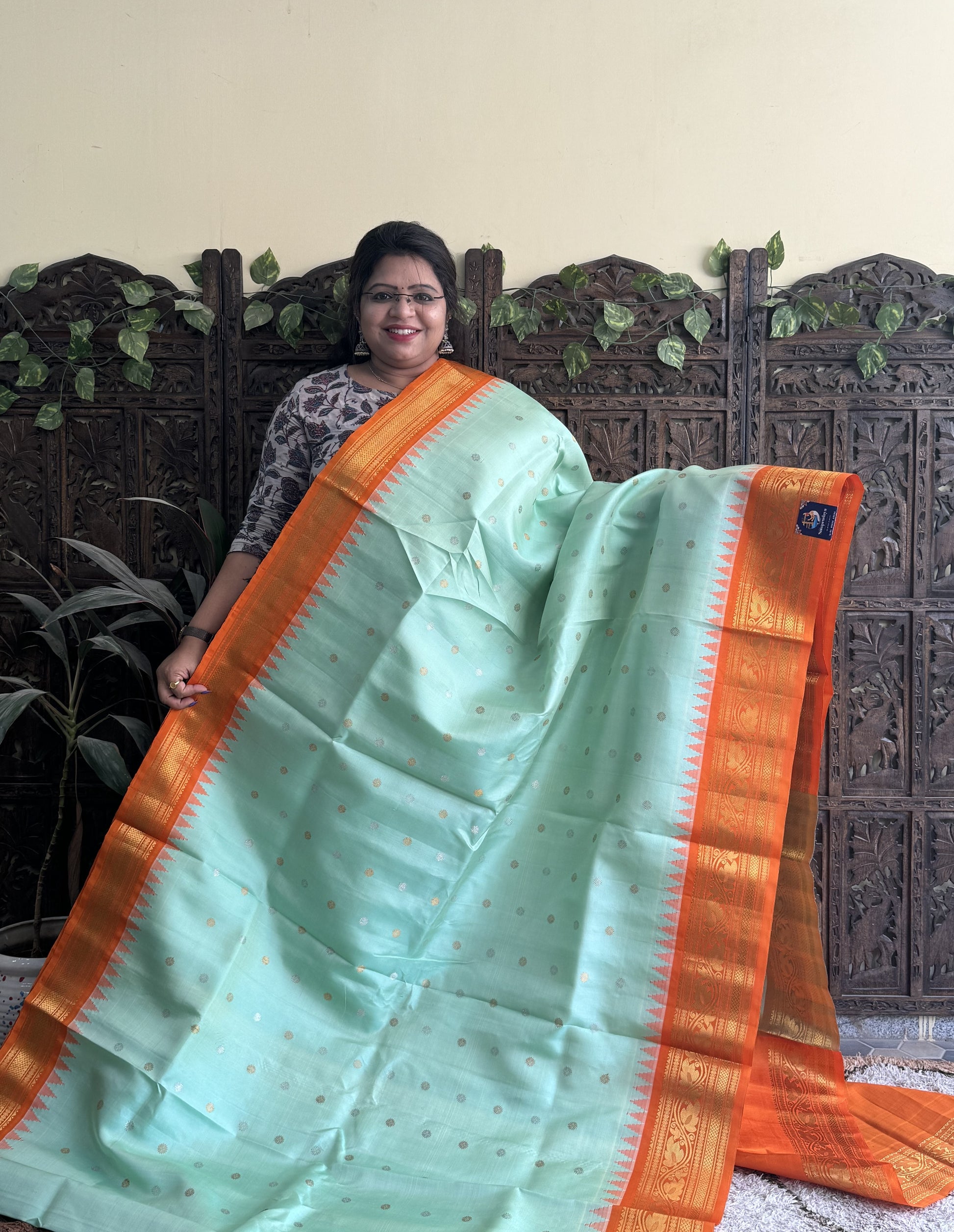 Gadwal Silk Saree Sea Green Colored Complemented With a Orange Zari Border - Sampradaya Designer Studio