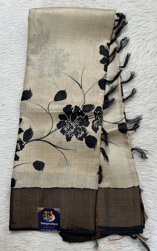 Tussar Silk Saree Cream colored complemented with a Black Colored Gold Zari border. - Sampradaya Designer Studio
