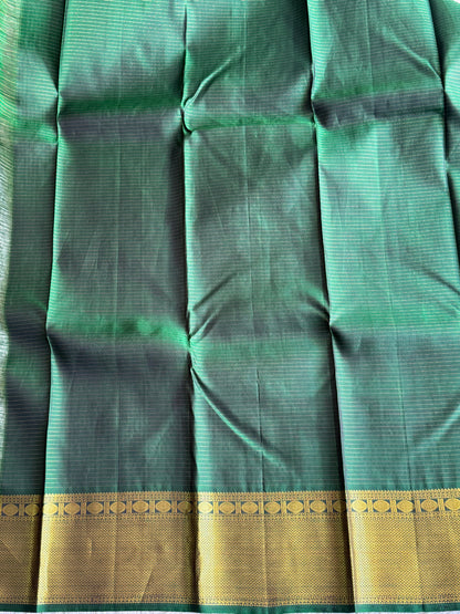 Pure Kanjivaram Silk Saree Light Bottle Green Colored Elegantly Paid with a Gold Zari Border.