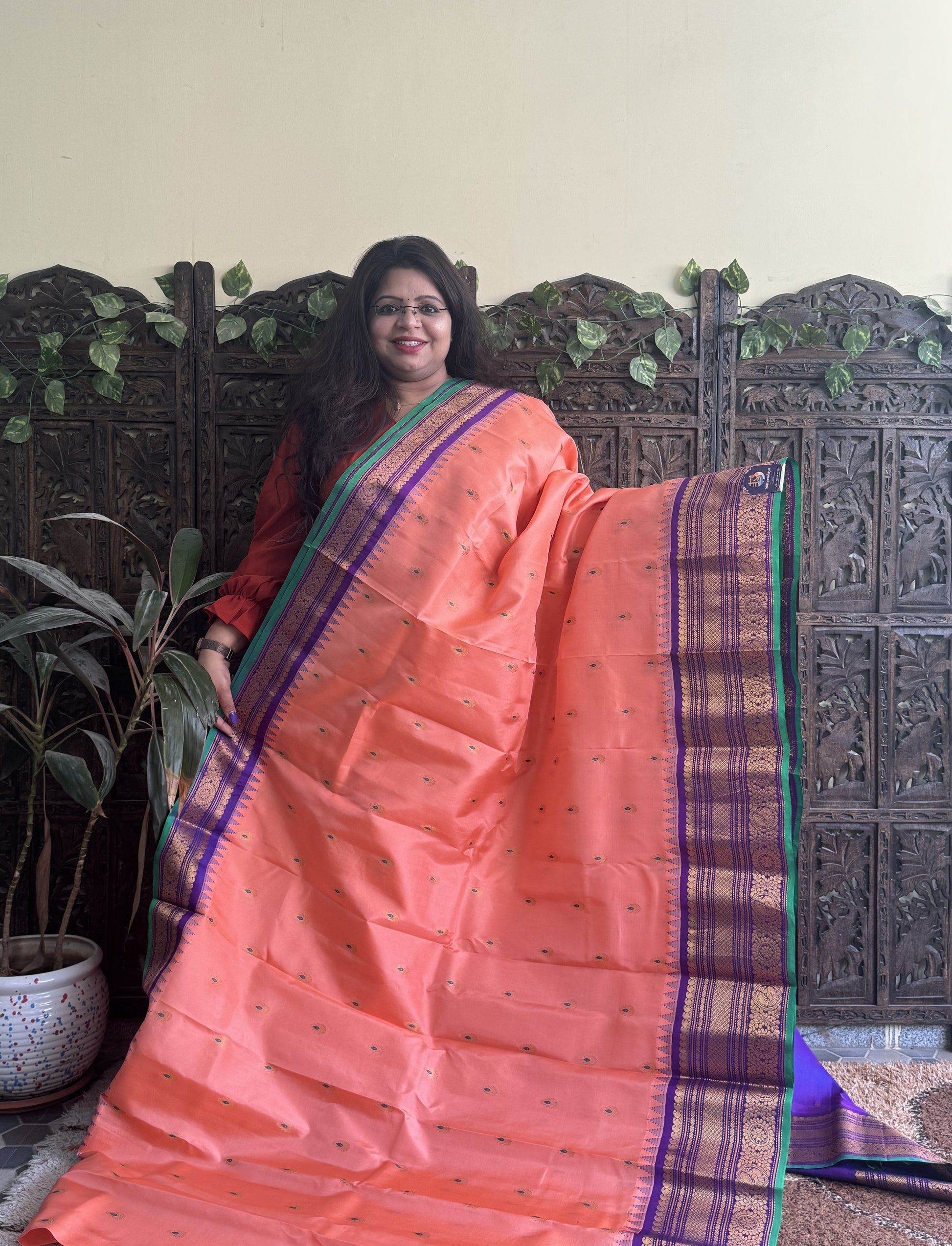Gadwal Pattu Saree Peach colored saree complemented with a Purple Zari border - Sampradaya Designer Studio