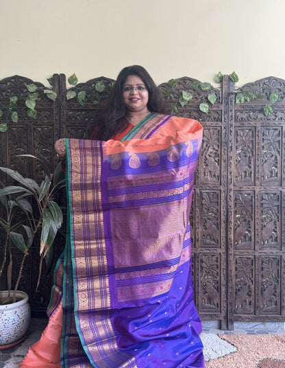 Gadwal Pattu Saree Peach colored saree complemented with a Purple Zari border - Sampradaya Designer Studio