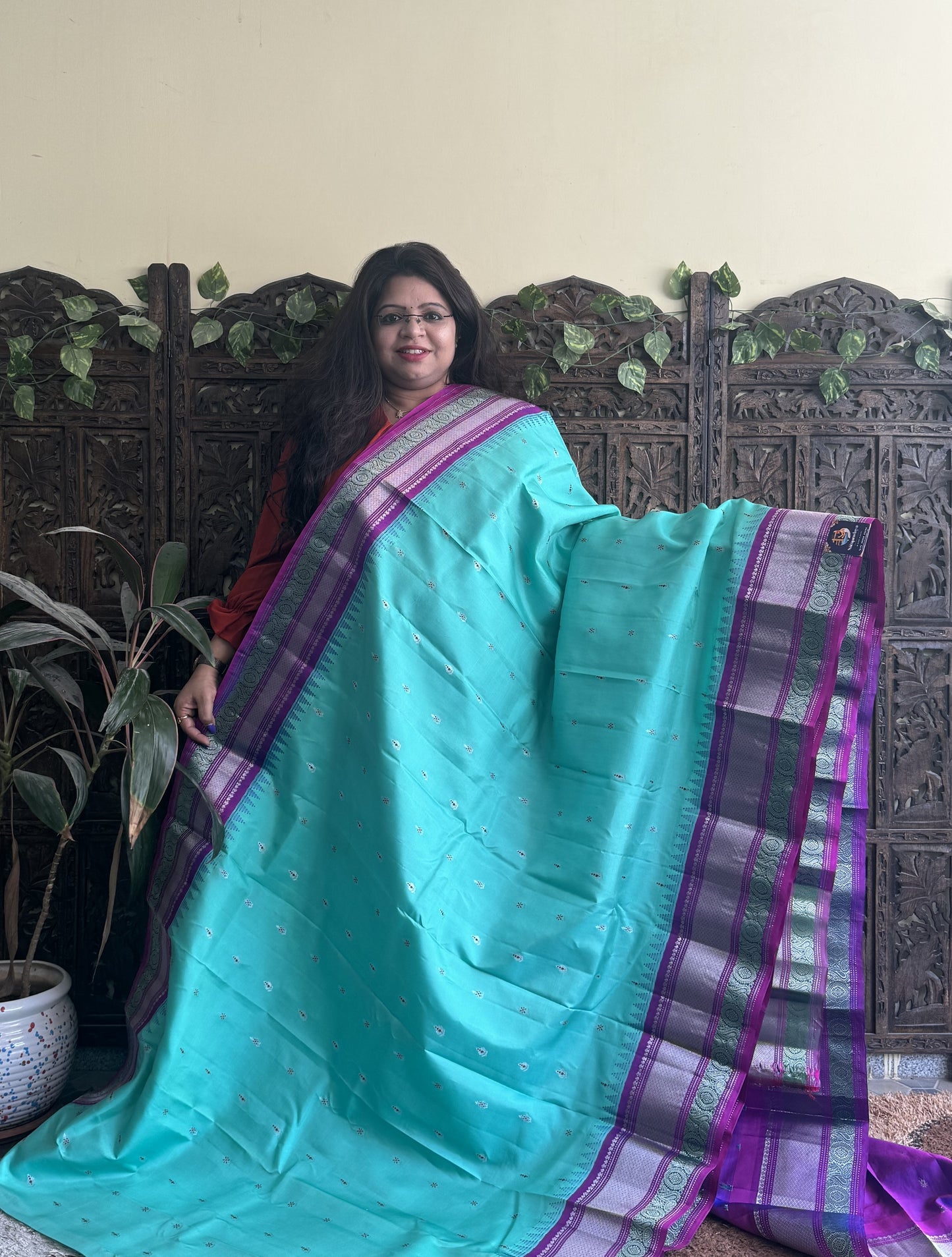Gadwal Pattu Saree Cyan colored saree complemented with a Purple Zari border - Sampradaya Designer Studio