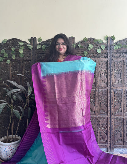 Gadwal Pattu Saree Light Turquoise Blue colored saree complemented with a Purple Checks border - Sampradaya Designer Studio