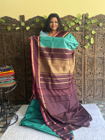 Pure Kanjivaram Silk Saree Teal Blue Colored Elegantly Paid with a Gold Zari Border.