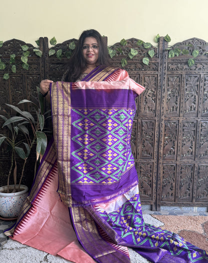 Ikkat Pattu Saree Peachish Pink colored complemented with a Kanchi border. - Sampradaya Designer Studio