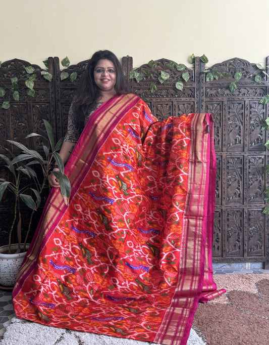 Ikkat Pattu Saree Red Orange colored complemented with a Kanchi border. - Sampradaya Designer Studio