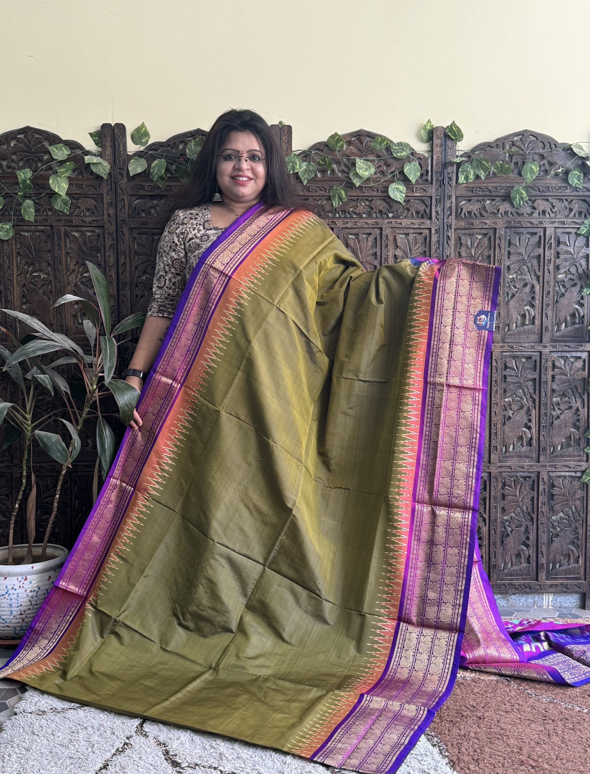Ikkat Pattu Saree Olive Green colored complemented with a Kanchi border. - Sampradaya Designer Studio